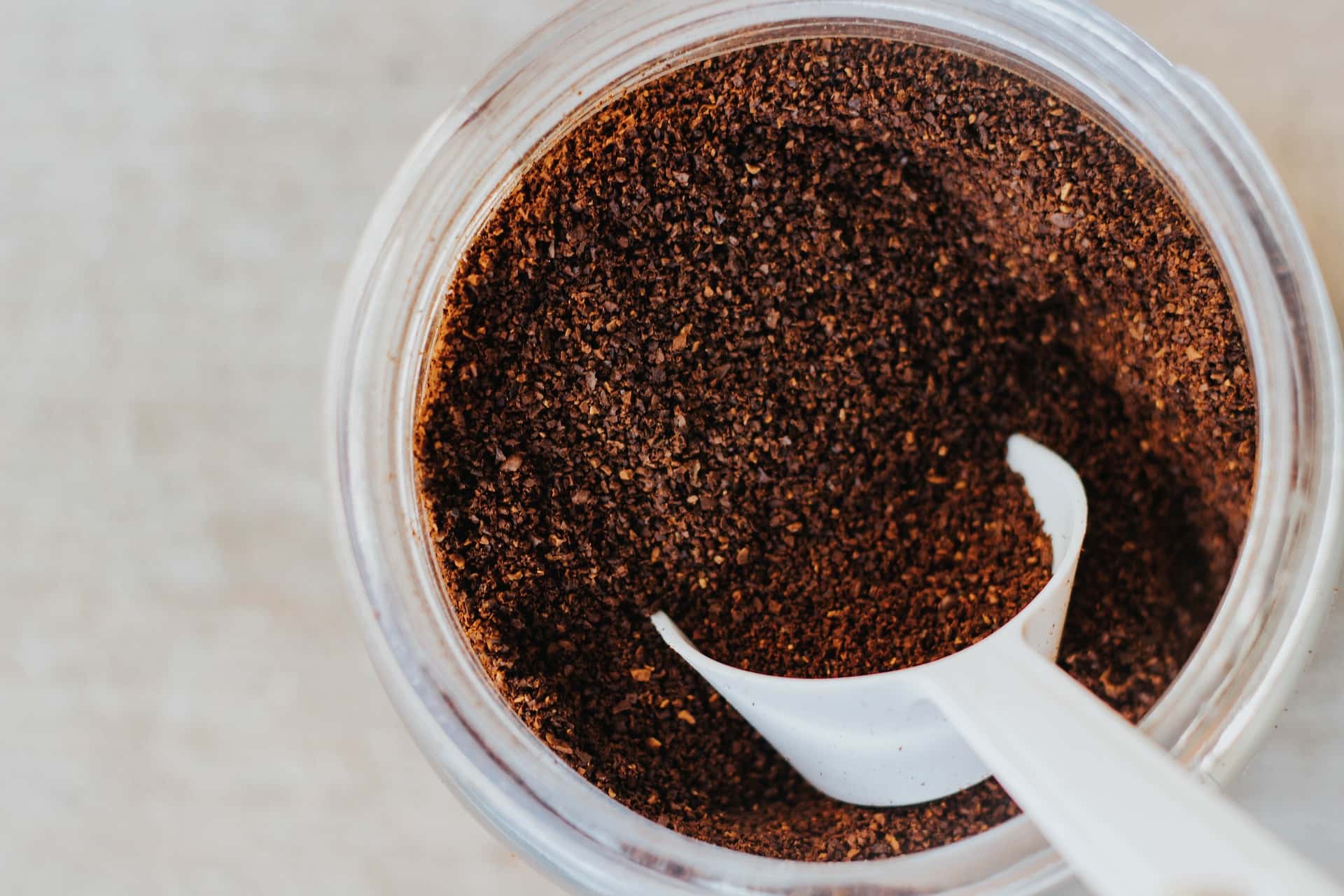 ground coffee in a jar with a scoop